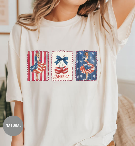White t-shirt with patriotic graphic design featuring women, an American flag, and the word 'America'.