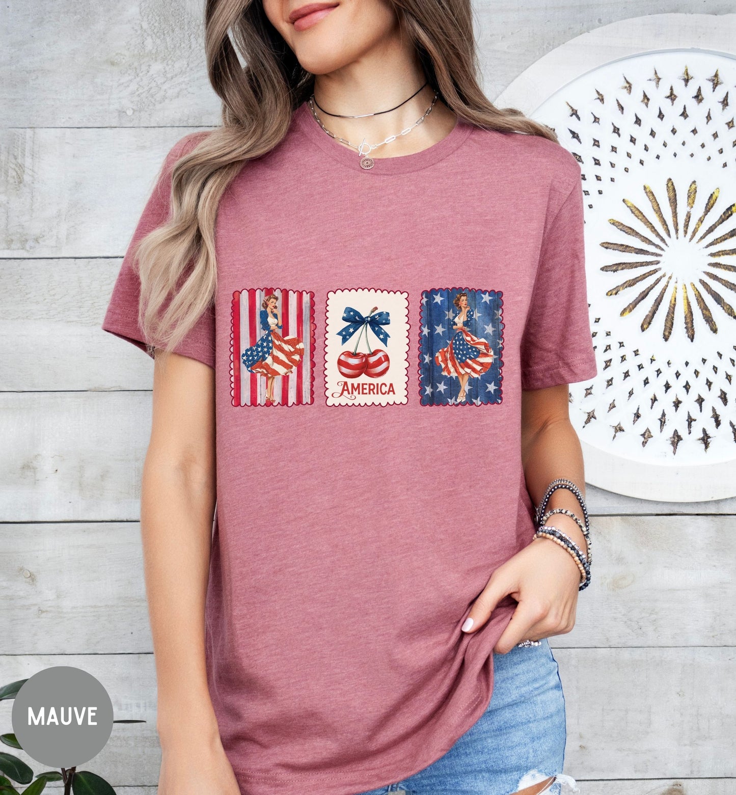 Person wearing a mauve t-shirt with patriotic graphics against a wooden wall.